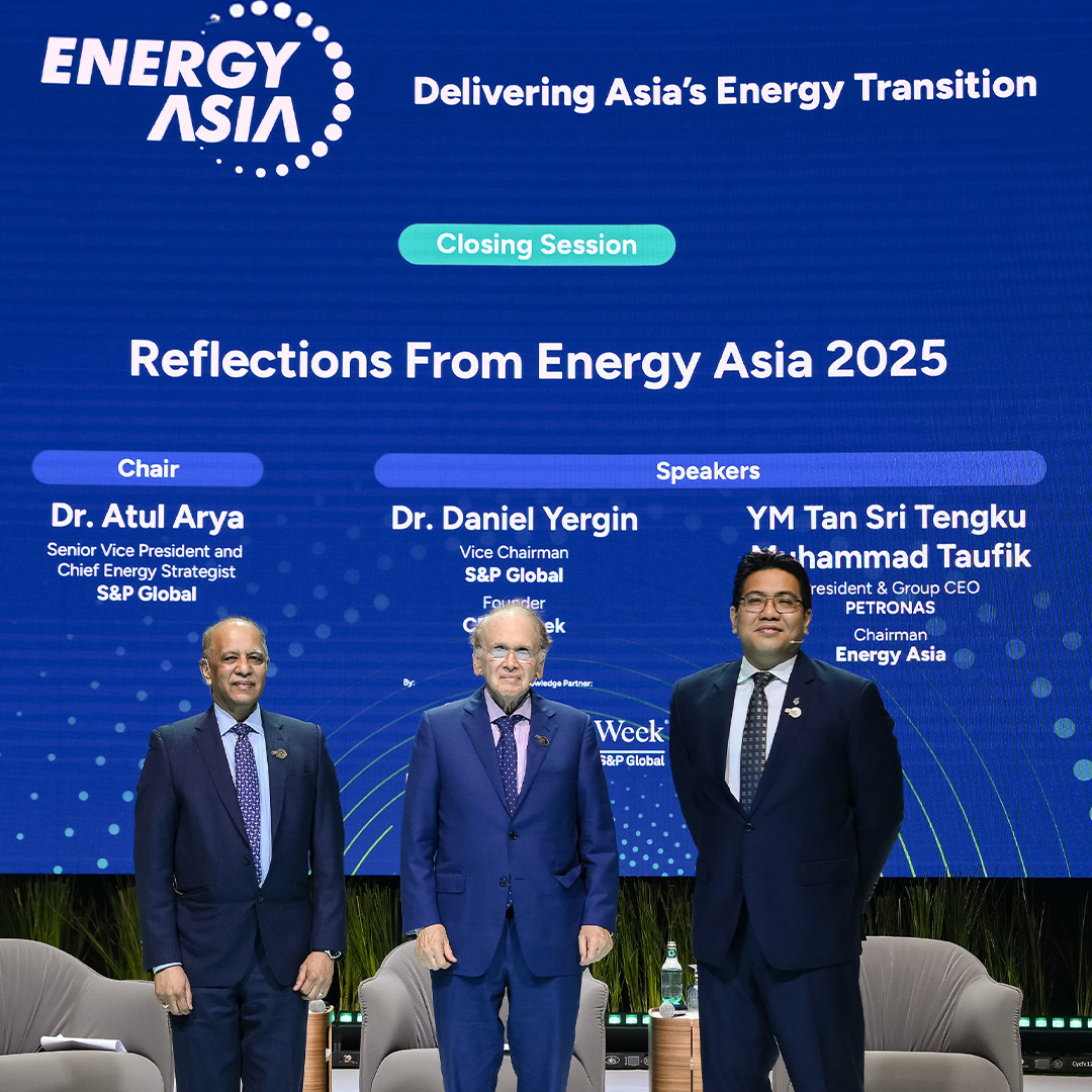 Dr. Atul Arya, Dr. Daniel Yergin, and Tan Sri Tengku Muhammad Taufik stand on stage during the closing session of Energy Asia 2025, with event graphics behind them.